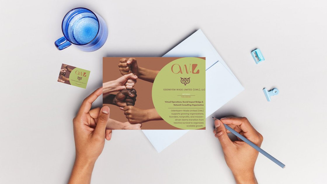 OWL postcard, business card and envelope laid out on a desk